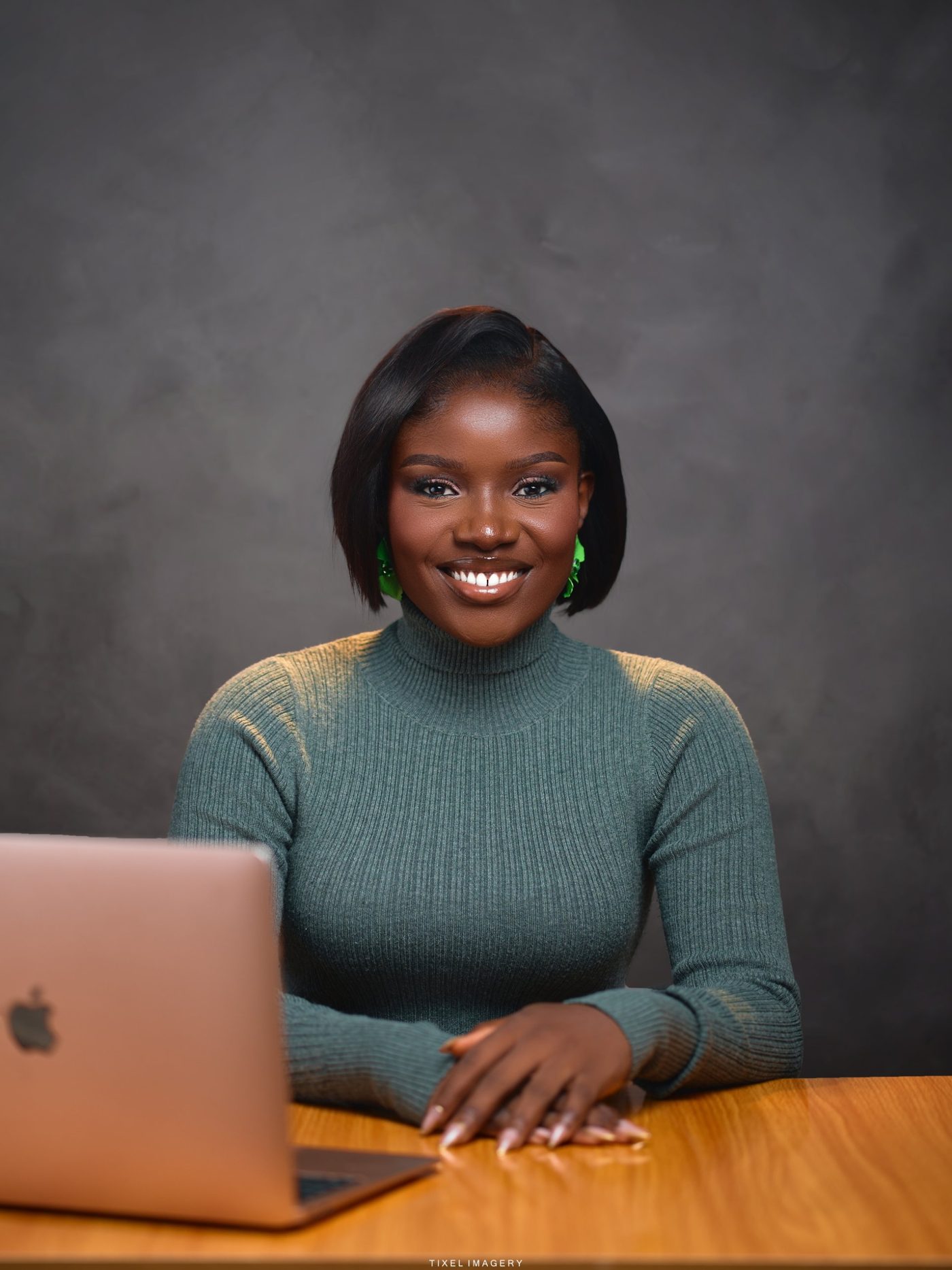 Sarah Adesemoye, co-founder of Growth-X, at her desk with a laptop.